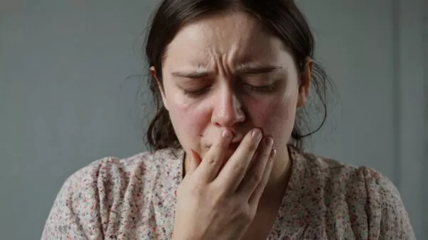 a person who feels unwell looking pale and vo 2